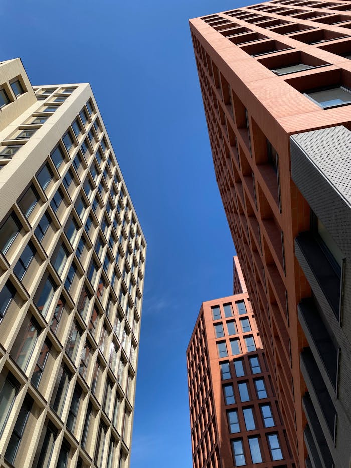 Contemporary architecture of skyscrapers against a clear blue sky in Manchester, UK.